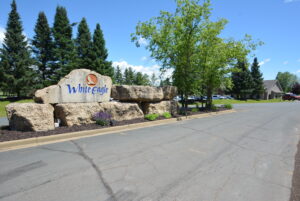 White Eagle Golf Course monument with clubhouse in background. www.durhamexecutivegroup.com