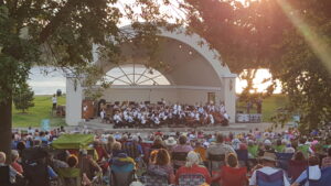 Residents enjoying a summer evening listening to a band at the Hudson WI Riverfront Park and band shell