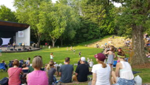 People in River Falls WI enjoying entertainment at the outdoor band shell