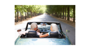 An elderly couple in convertible enjoying retirement and a nice warm weather day